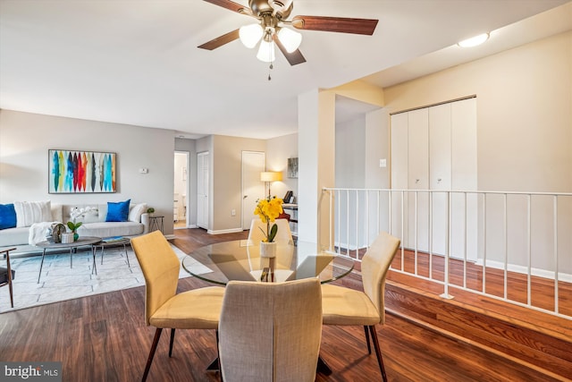 dining room featuring ceiling fan and dark wood-type flooring