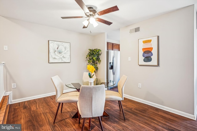 dining room with ceiling fan and dark wood-type flooring