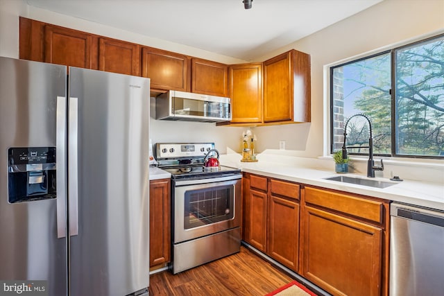 kitchen with dark hardwood / wood-style floors, sink, and stainless steel appliances