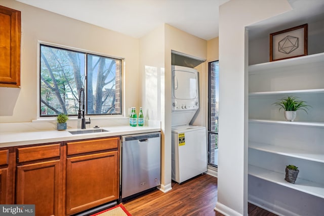 kitchen with dishwasher, dark hardwood / wood-style flooring, stacked washer and dryer, and sink