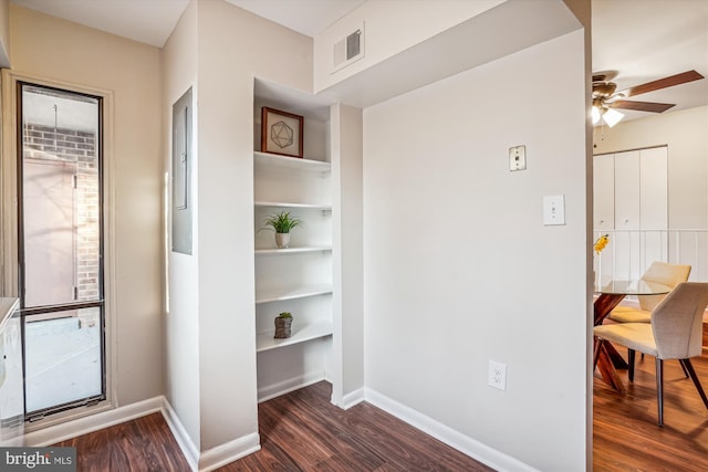 hallway with dark hardwood / wood-style flooring and built in features