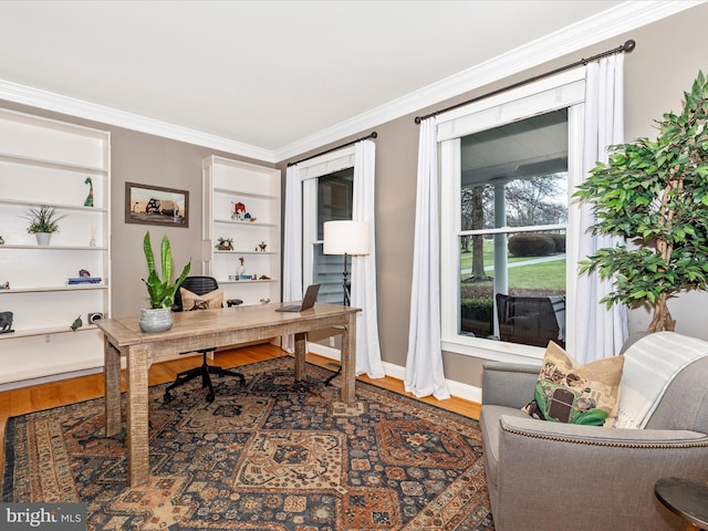 office area with built in features, dark wood-type flooring, and crown molding