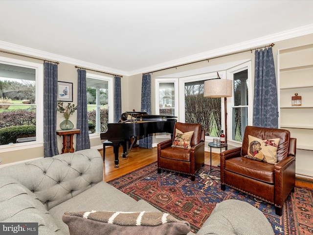 living room featuring hardwood / wood-style flooring, a wealth of natural light, and crown molding