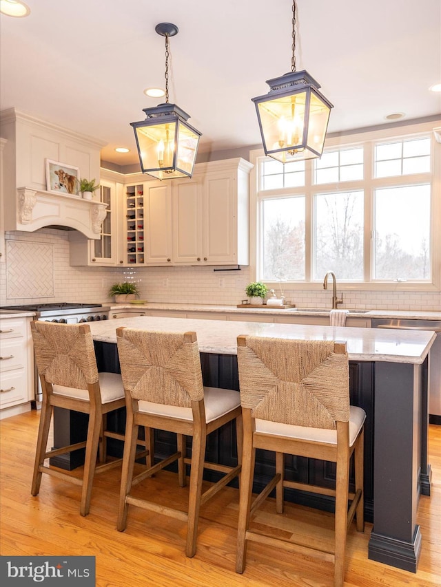 kitchen with plenty of natural light, a kitchen island, and light hardwood / wood-style flooring