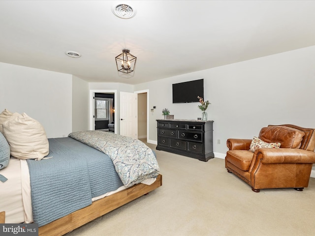 carpeted bedroom featuring a notable chandelier