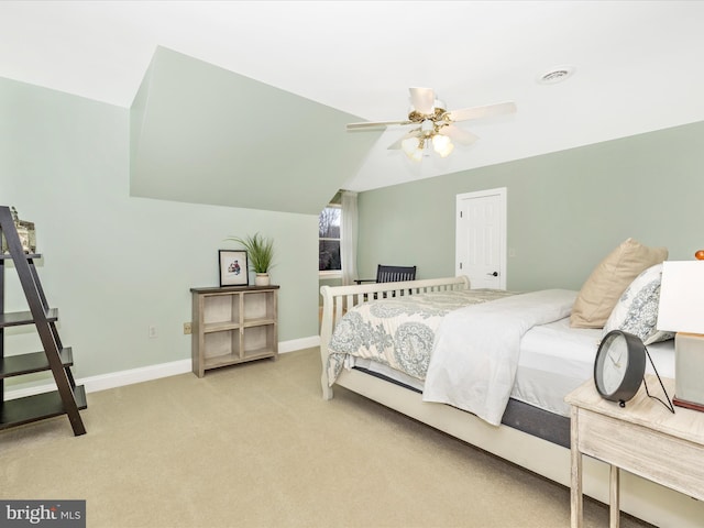 bedroom featuring ceiling fan, light colored carpet, and lofted ceiling