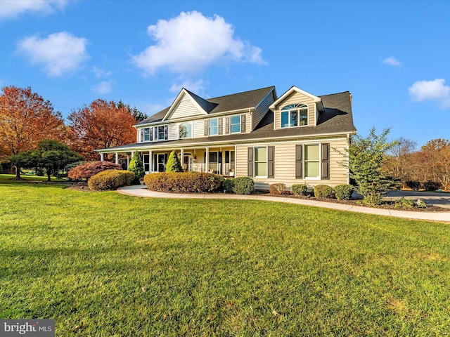 view of front of house featuring covered porch and a front yard