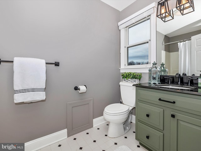 bathroom featuring vanity, toilet, and curtained shower