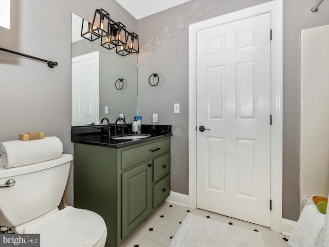 bathroom with vanity, toilet, and a chandelier