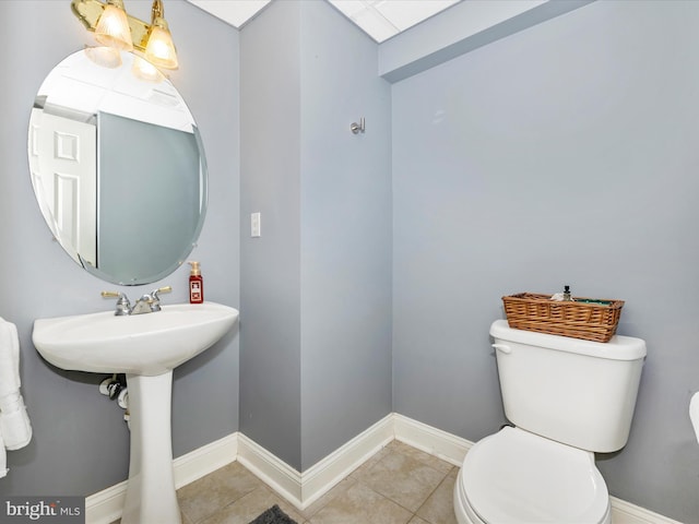 bathroom with tile patterned floors, sink, and toilet