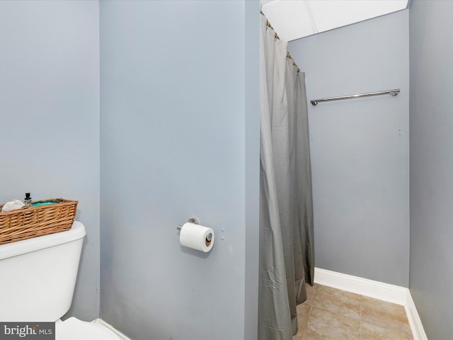 bathroom with tile patterned floors and toilet