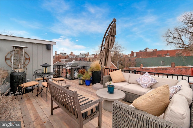 wooden deck featuring a grill and an outdoor living space