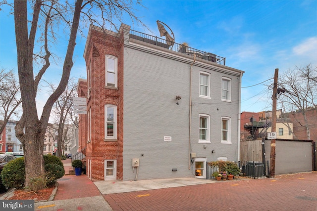 back of property featuring a balcony and central air condition unit