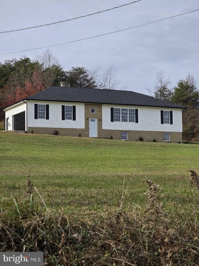 view of front facade with a garage and a front lawn