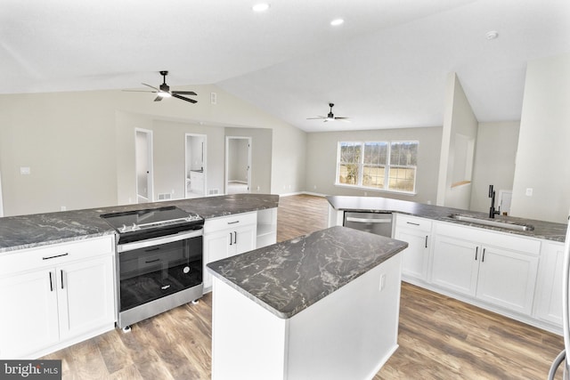 kitchen featuring a center island, sink, white cabinets, and appliances with stainless steel finishes