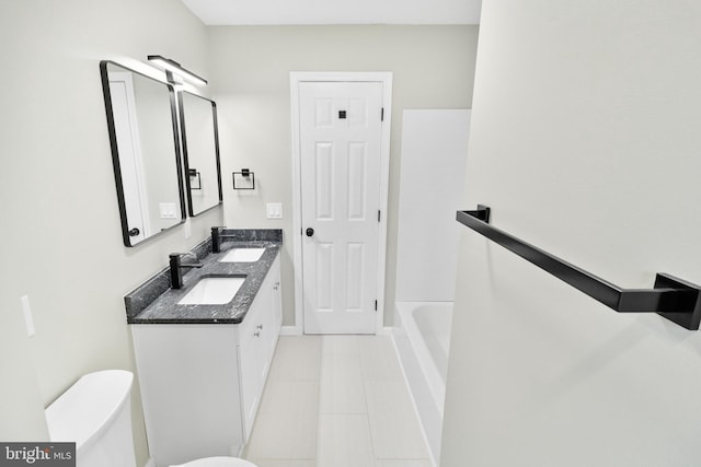 bathroom featuring tile patterned flooring, vanity, and toilet