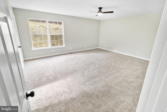 empty room with carpet floors and ceiling fan