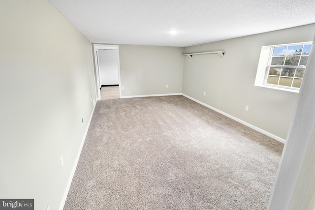 carpeted spare room with a textured ceiling