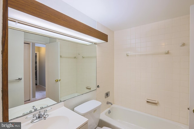 full bathroom featuring tiled shower / bath combo, toilet, and vanity