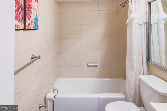 bathroom featuring shower / bath combo and toilet