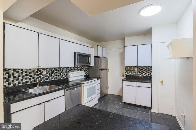 kitchen with backsplash, white cabinetry, sink, and appliances with stainless steel finishes