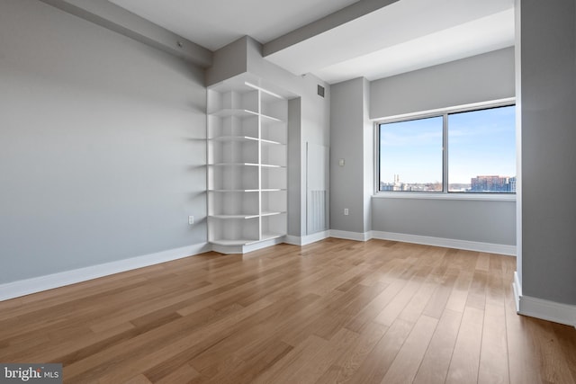 unfurnished room with light hardwood / wood-style floors