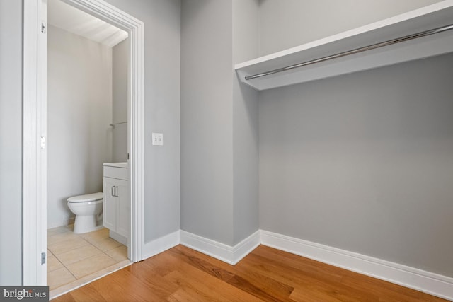 bathroom with hardwood / wood-style floors and toilet