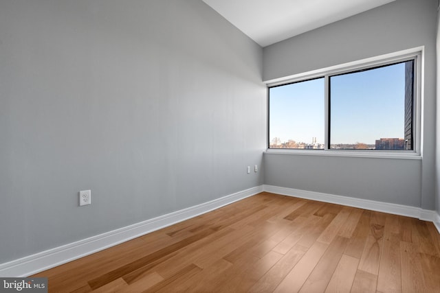 spare room with hardwood / wood-style flooring