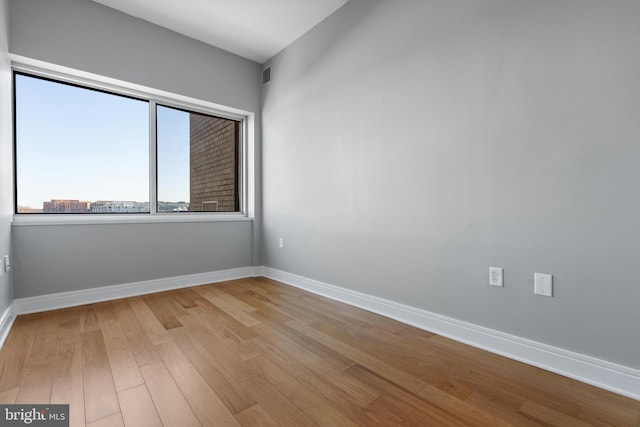 empty room with light hardwood / wood-style flooring