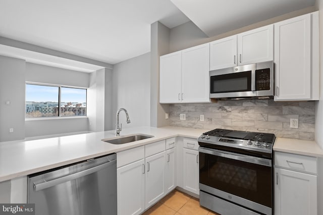 kitchen with sink, white cabinets, and stainless steel appliances