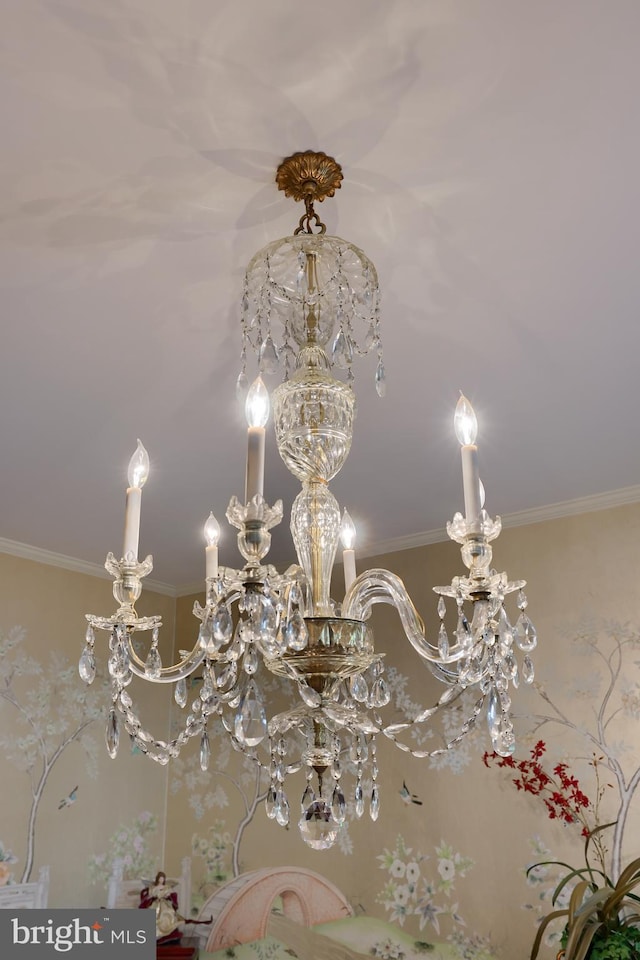 details with ornamental molding and a notable chandelier