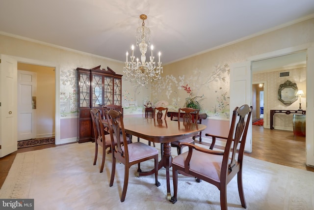 dining area featuring a notable chandelier and ornamental molding