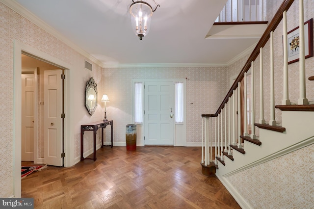 foyer with parquet floors and ornamental molding