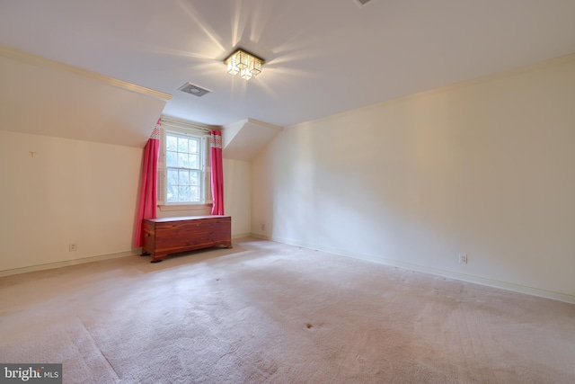 additional living space featuring light carpet and lofted ceiling