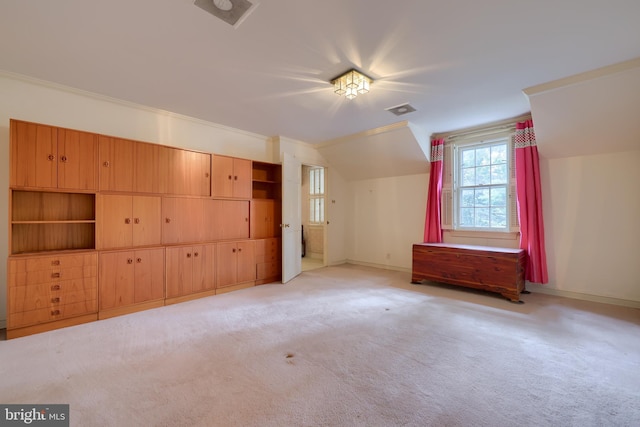 bonus room with light colored carpet and vaulted ceiling