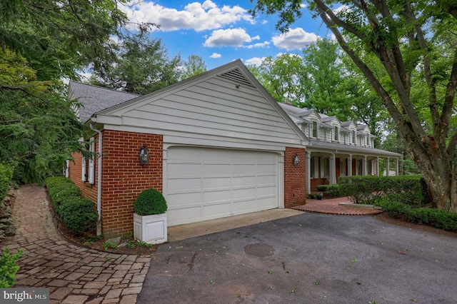 view of front of property featuring covered porch and a garage