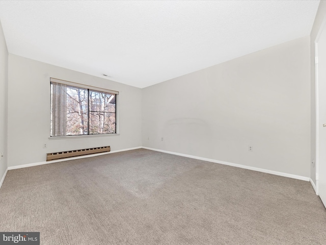 carpeted empty room with baseboard heating