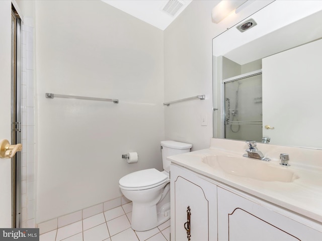 bathroom featuring tile patterned flooring, vanity, toilet, and walk in shower