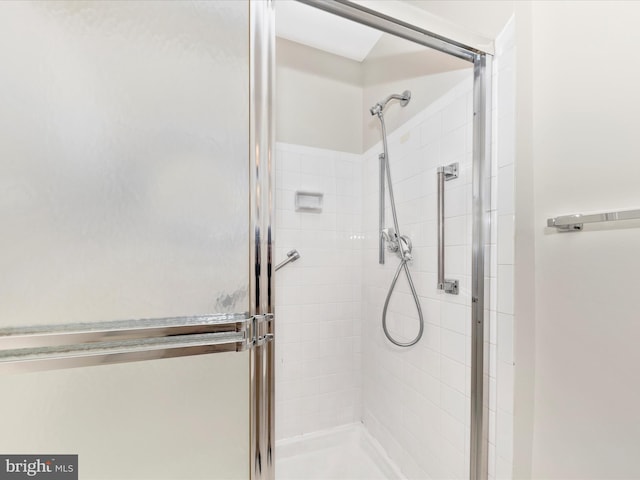 bathroom with a shower with door