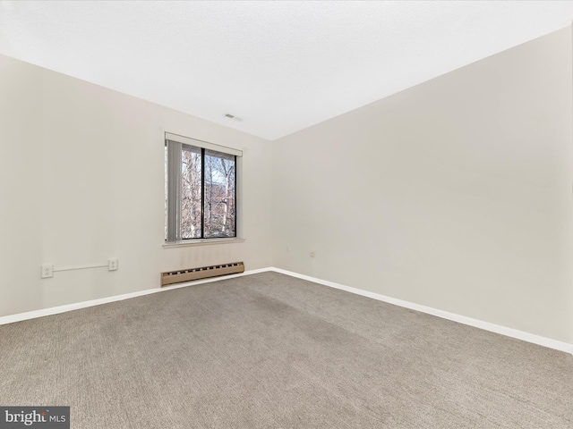 carpeted empty room with baseboard heating