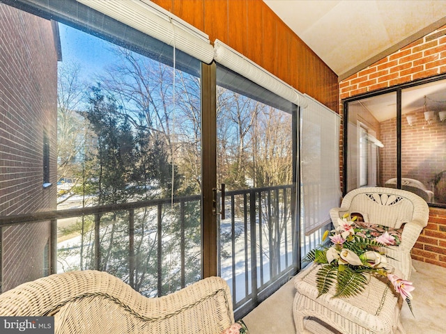 sunroom featuring lofted ceiling