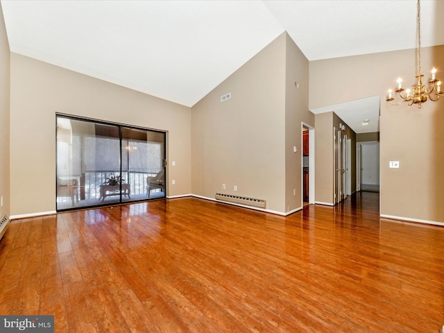 unfurnished living room with hardwood / wood-style floors, baseboard heating, high vaulted ceiling, and a chandelier