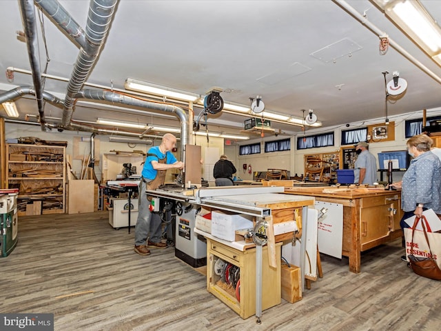 interior space with a workshop area and wood-type flooring