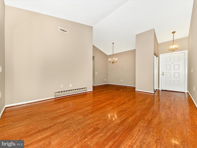 unfurnished room with hardwood / wood-style floors, vaulted ceiling, an inviting chandelier, and baseboard heating