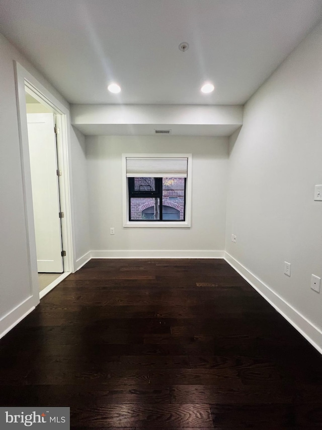 spare room featuring dark hardwood / wood-style flooring