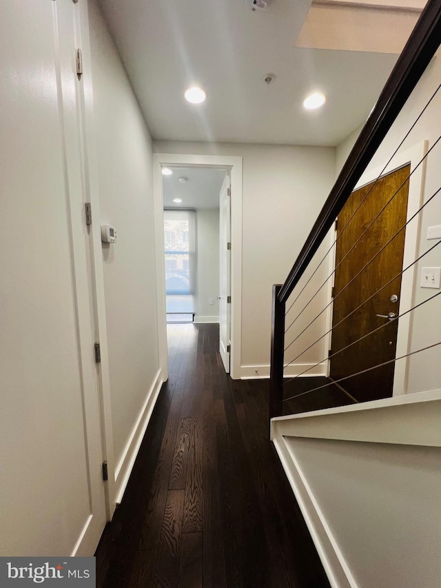 hall with dark hardwood / wood-style flooring