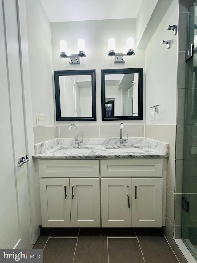 bathroom with vanity and an enclosed shower