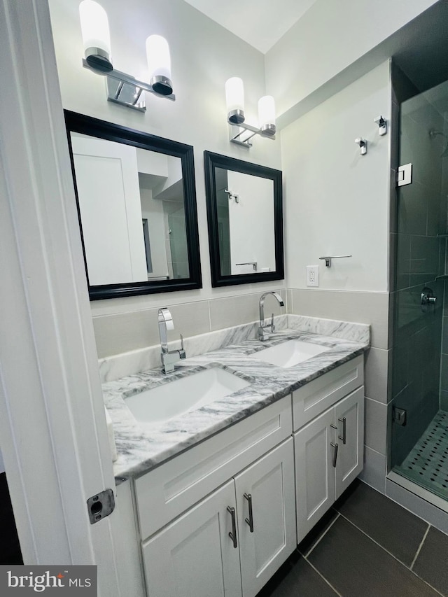 bathroom featuring tile patterned floors, vanity, and walk in shower