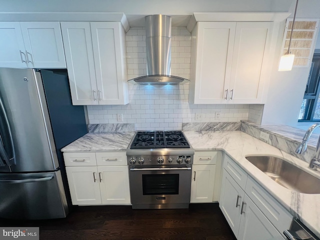 kitchen with sink, stainless steel appliances, wall chimney range hood, dark hardwood / wood-style floors, and white cabinets