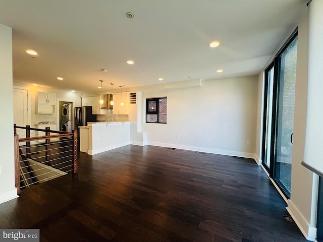 living room featuring dark hardwood / wood-style flooring and a healthy amount of sunlight